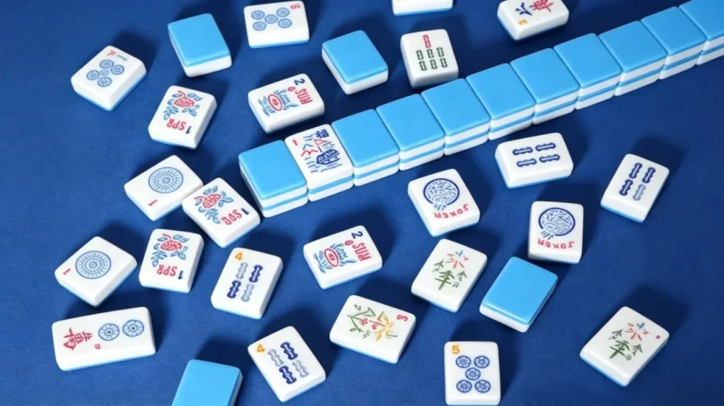 American Mahjong tiles on blue felt showing the joker tile and suit tiles